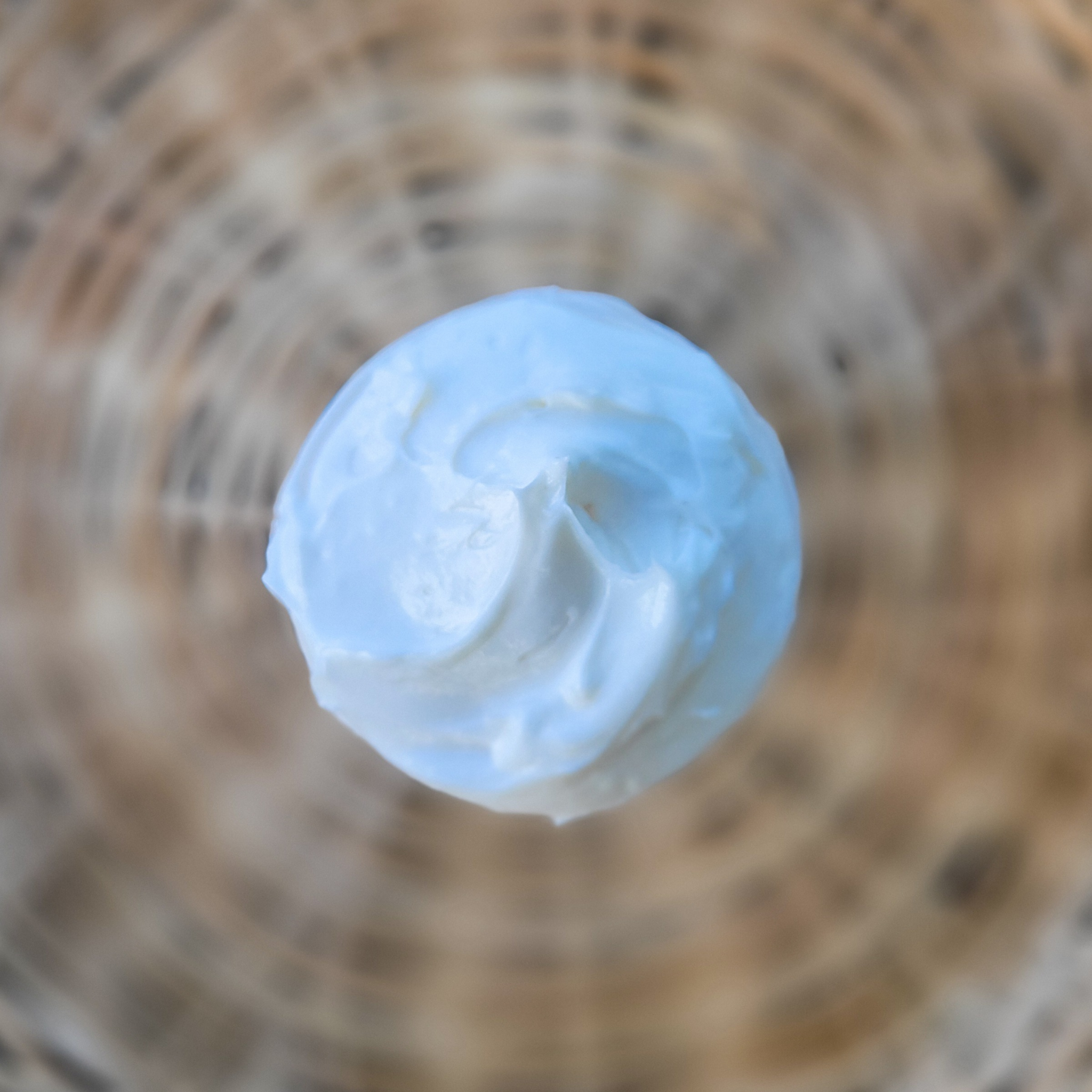 Close-up of magnesium cream without lid on a blurred natural background
